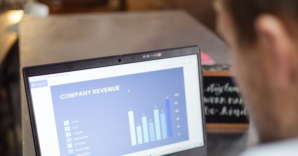 Company revenue chart open on a laptop, highlighter in hand